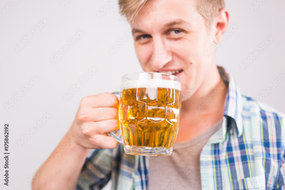 Man drinks beer. Handsome young guy drinking lager pint on white background Man drinks beer. Handsome young guy drinking lager pint on white background