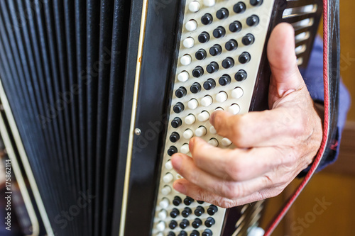 Musician hand playing accordions closeup