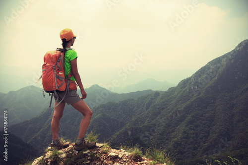 successful woman hiker enjoy the view on the top of mountain