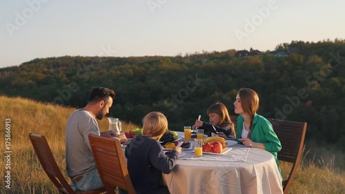 Happy family have lunch in nature.
