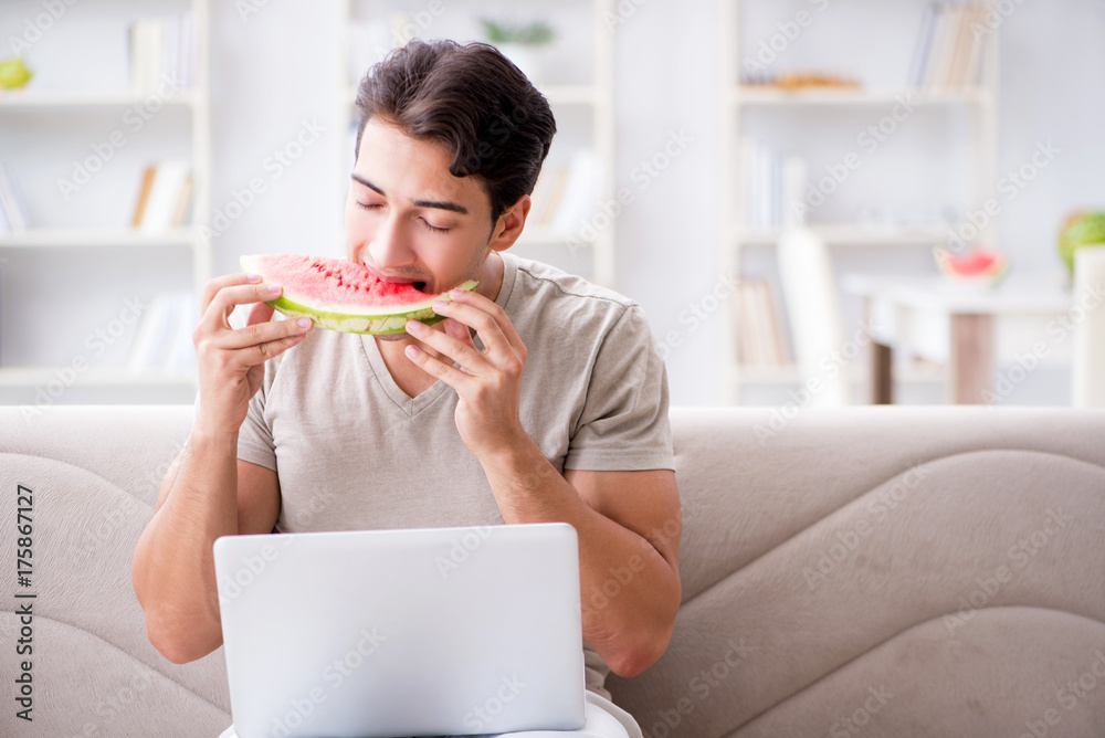 Man eating watermelon at home Man eating watermelon at home