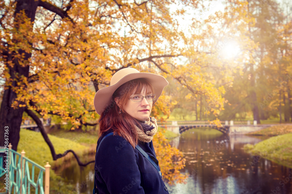 Portrait of  woman in an autumn park.