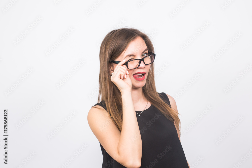 Successful business woman. Portrait sexy pretty confident girl with glasses winking isolated white background wall. Positive emotion Successful business woman. Portrait sexy pretty confident girl with glasses winking isolated white background wall. Positive emotion
