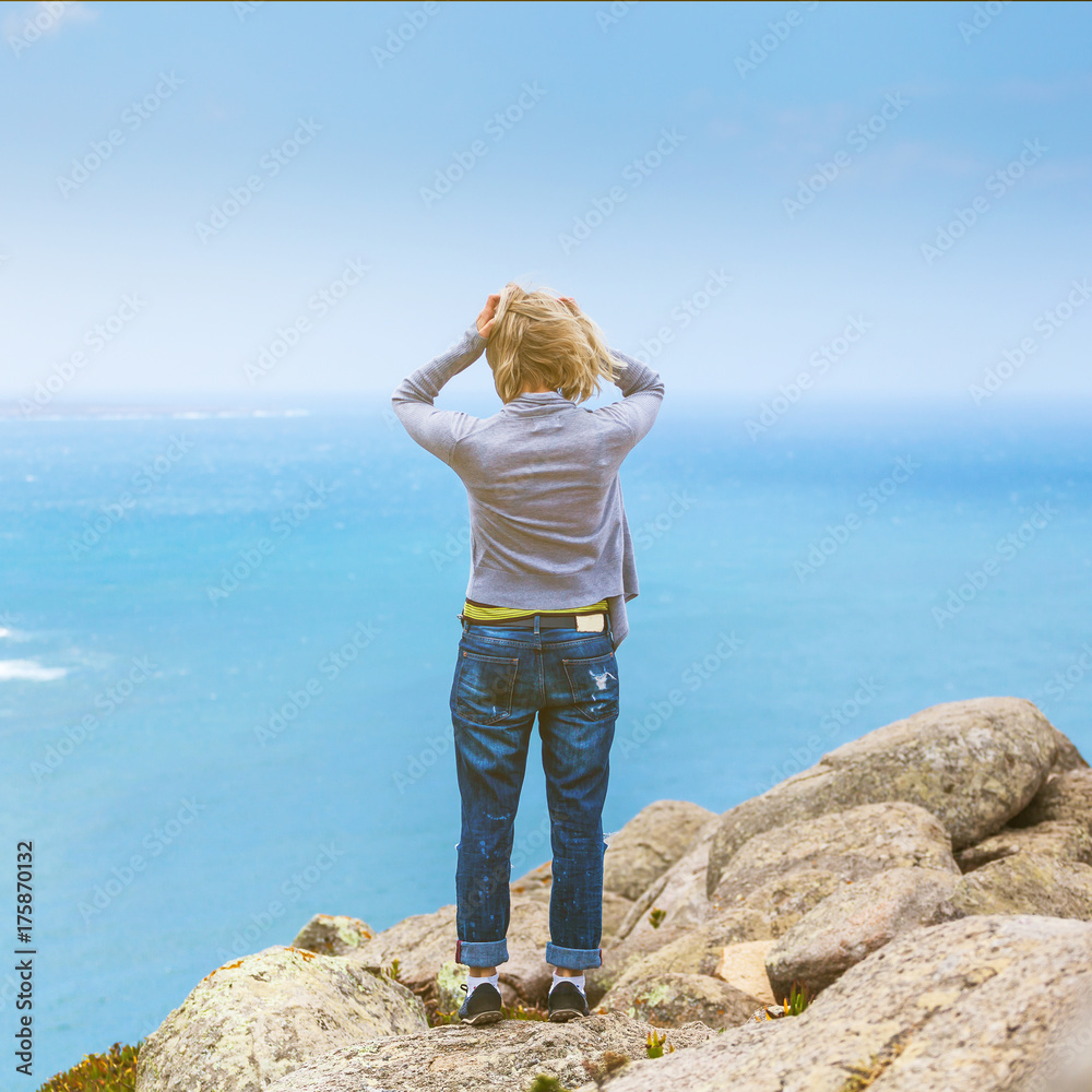 Happy female tourist standing on Cape Roca, Sintra, Portugal