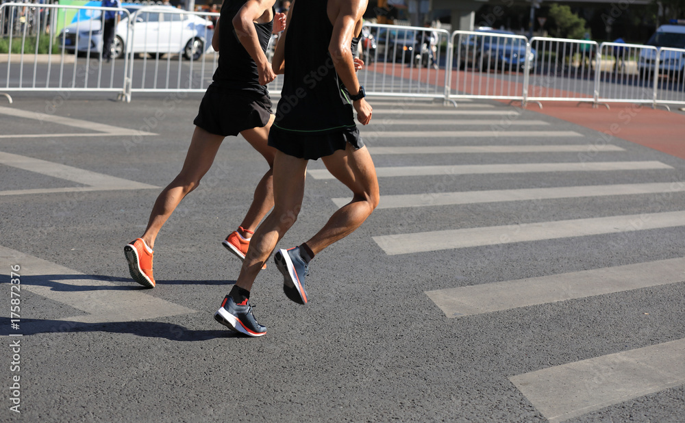 Fototapeta premium Marathon runners running on city road