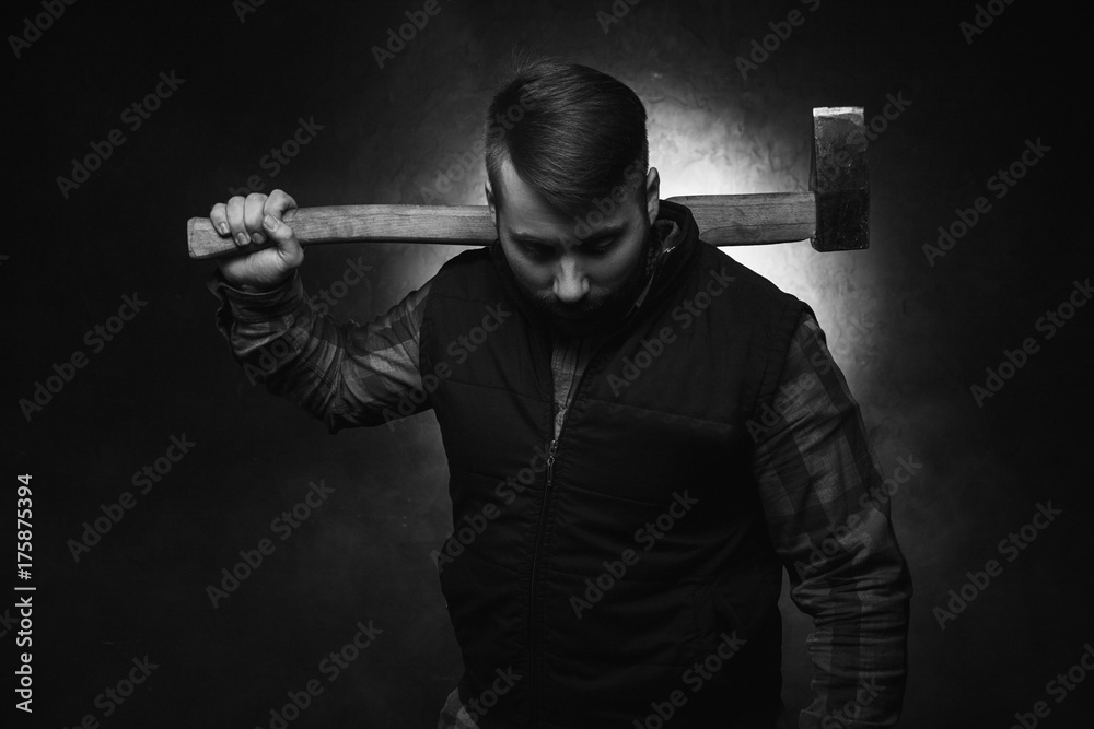 Scary axeman. Angry maniac with axe. Dangerous rural man on black background closeup, aggressive look, threat concept