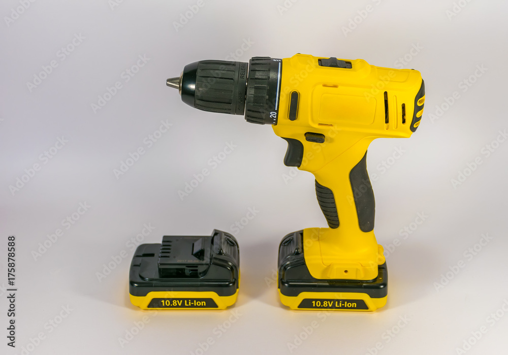 Yellow hand-held cordless screwdriver for professional work.