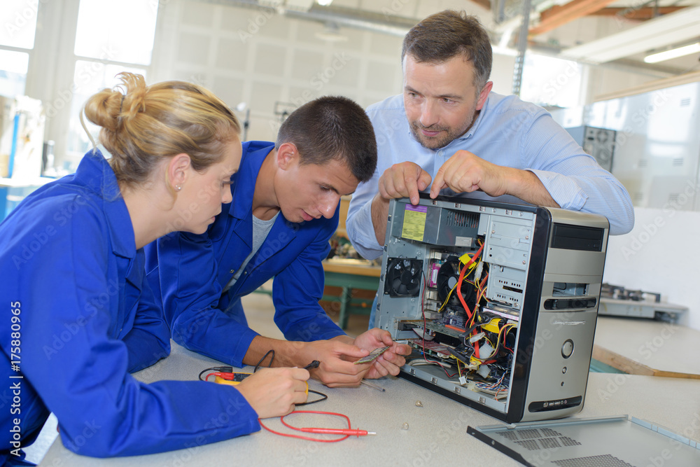 Students learning to repair computer Students learning to repair computer