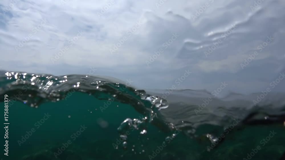 Waves on the ocean. The camera goes under water. Video recorded in slow motion. 