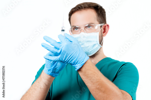 Doctor with syringe ready to make injection.