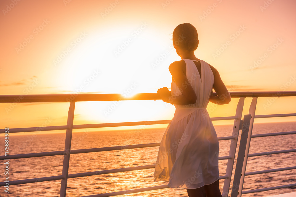 Cruise ship vacation woman travel watching sunset at sea ocean view. Elegant lady in white dress relaxing on deck balcony, luxury holiday destination. - obrazy, fototapety, plakaty 