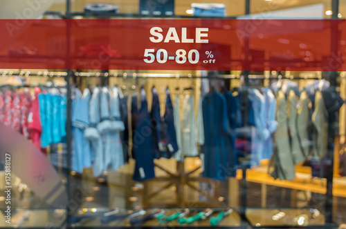 Sale 50-80% off mock up advertise display frame setting over the Abstract blurred photo of clothing store in a shopping mall, shopping concept