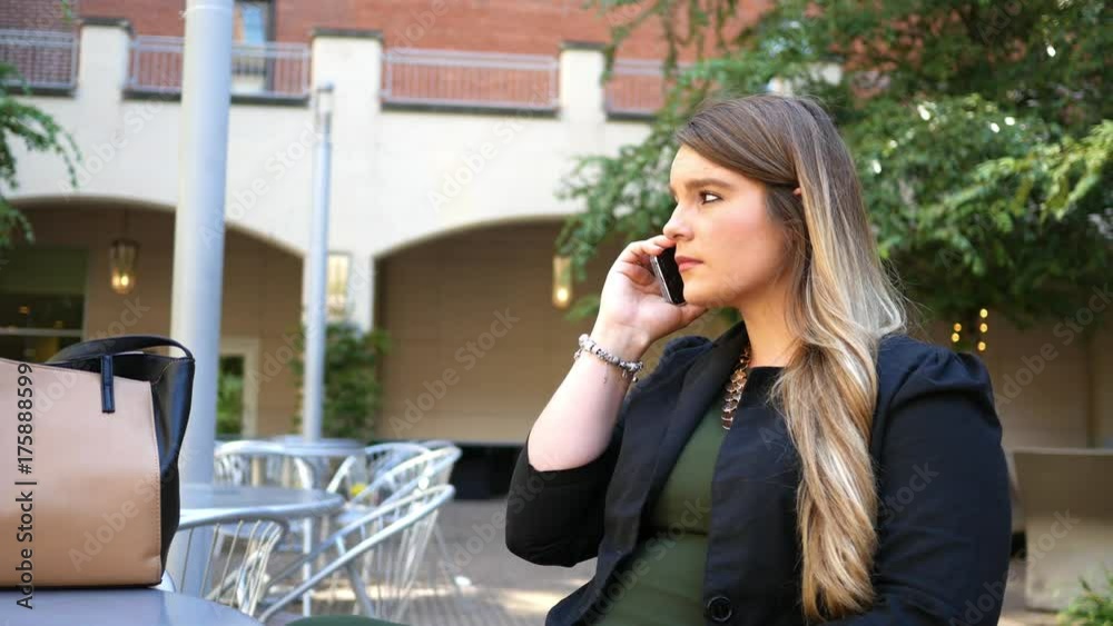 Young College Professor talks on her smartphone on campus Young College Professor talks on her smartphone on campus