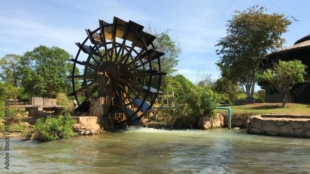 Water-wheels turbine rotating in the garden Water-wheels turbine rotating in the garden