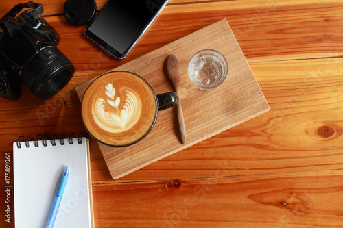 black telephone, notebook, pen, camera, vintage brown coffee and coffee grinder on gold wooden