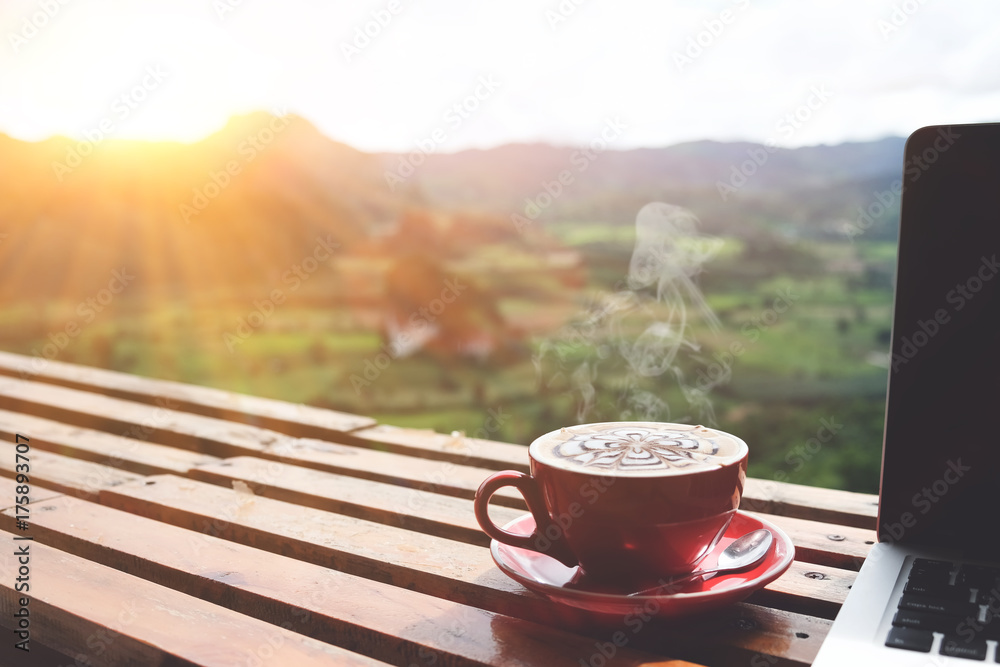 Coffee morning and laptop on wooden table with beautiful mountain background. Worklife balance concept - obrazy, fototapety, plakaty 
