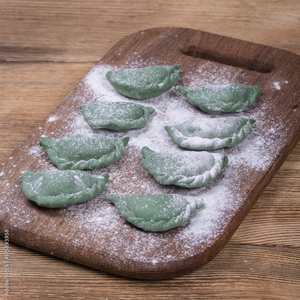 Green crude pelmeni with spirulina. Ukrainian and Russian dishes - vareniki  or dumplings with beef meat or mashed potatoes or cottage cheese Stock  Photo | Adobe Stock