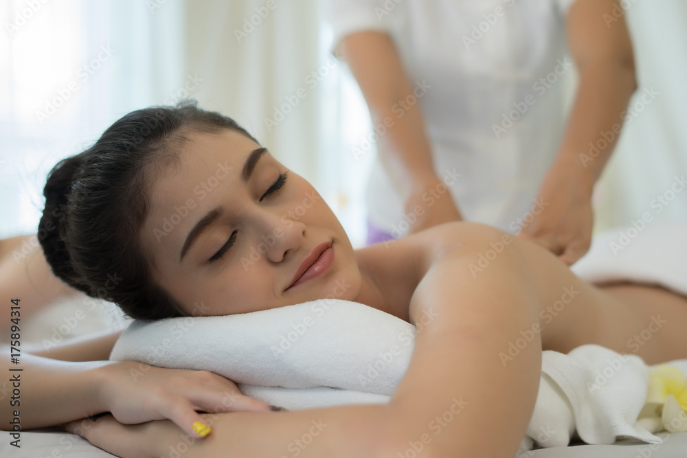 Young beautiful woman relaxing during massage in spa salon. Young beautiful woman relaxing during massage in spa salon.