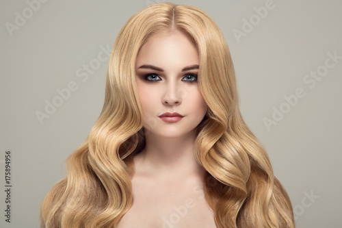 Blonde woman with long curly beautiful hair.