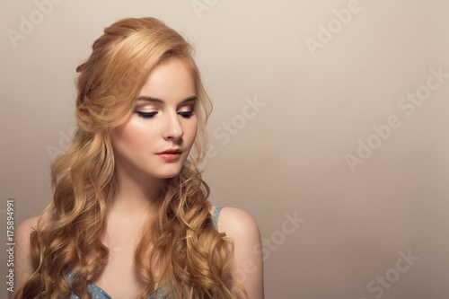 Portrait of young beautiful blonde woman. Hairstyle and make-up.