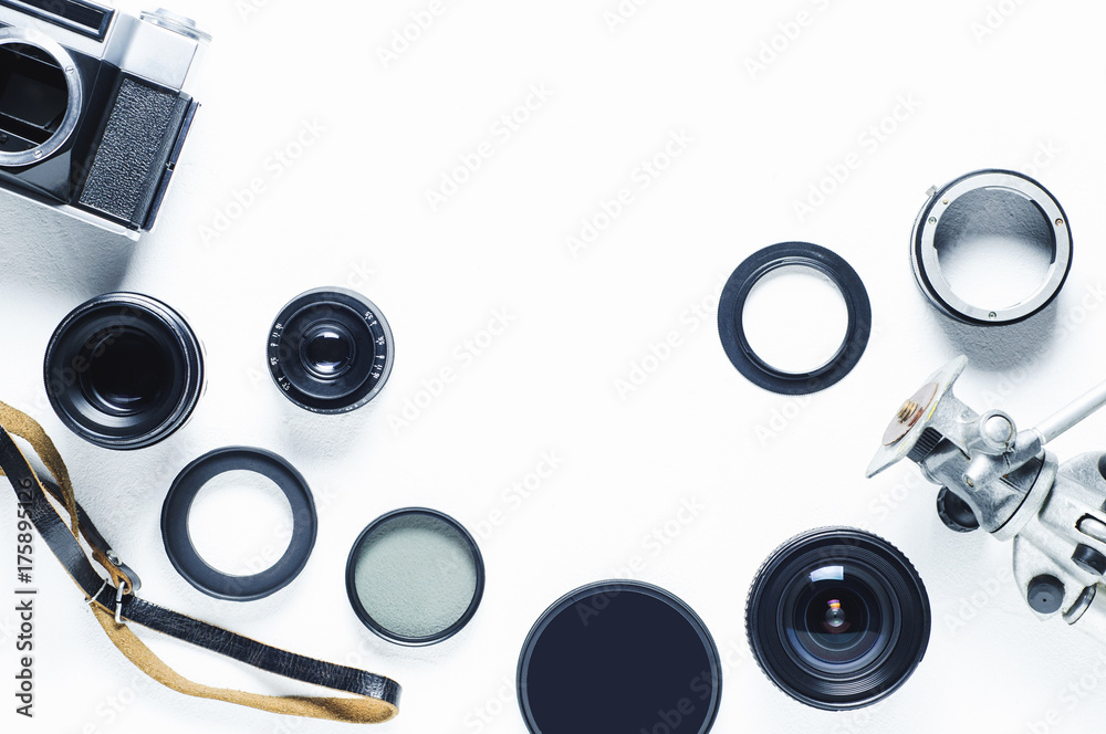 Film camera, lenses and equipment of the photographer on a white background - obrazy, fototapety, plakaty 