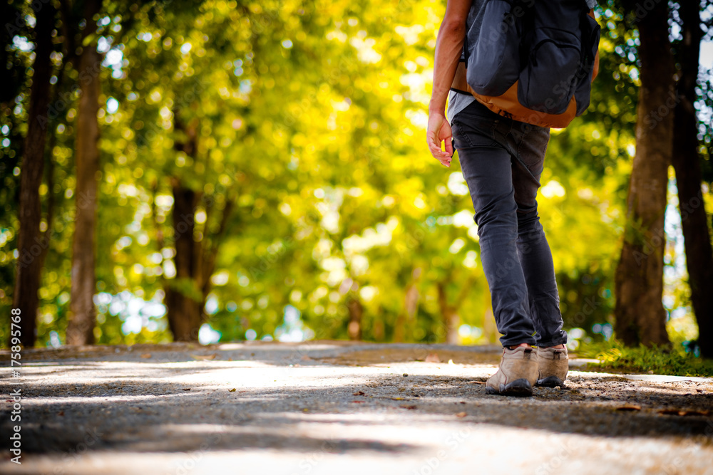 Man traveler traveling walking with backpack at the jungle on holiday at weekend on background nature view Man traveler traveling walking with backpack at the jungle on holiday at weekend on background nature view