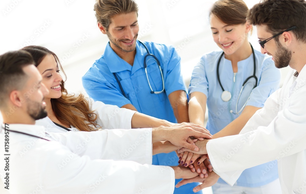 Doctors and nurses stacking hands. concept of mutual aid. Doctors and nurses stacking hands. concept of mutual aid.