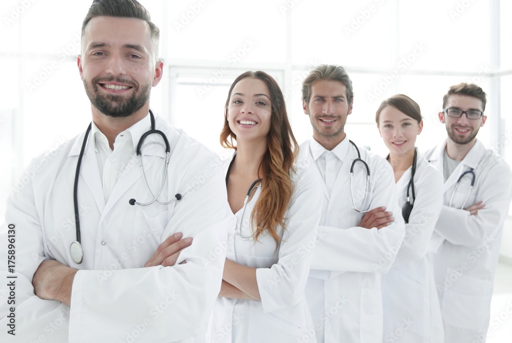 Group of happy successful doctors standing in a row in the hospital Group of happy successful doctors standing in a row in the hospital