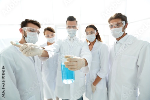 closeup of a group of medical workers working with liquids