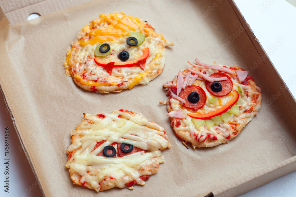 Halloween creative scary food monster zombie face with eyes pizza snack  with mozzarella, basil and sausage in craft box. Traditional holiday  celebration party decoration recipe Stock Photo | Adobe Stock