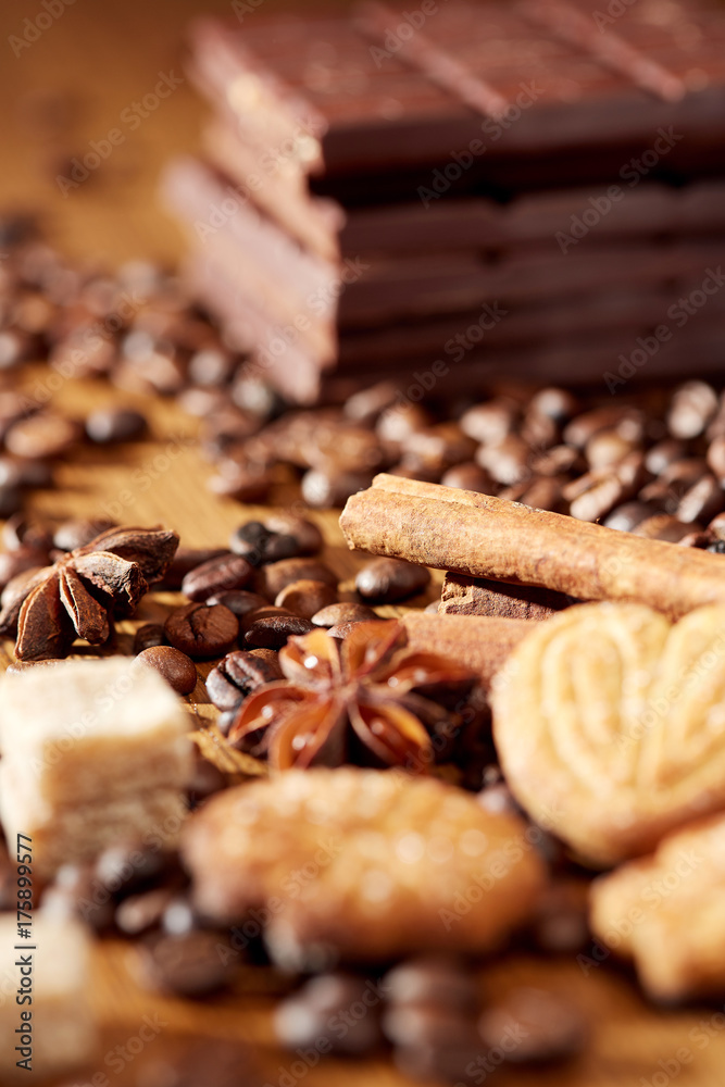 Aroma coffee chocolate cookies and spices on the wooden table. Dark wooden background. Top view. Close. Closeup. Aroma coffee chocolate cookies and spices on the wooden table. Dark wooden background. Top view. Close. Closeup.