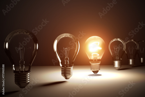 A row of light bulbs. One is glowing. 3D rendered illustration.