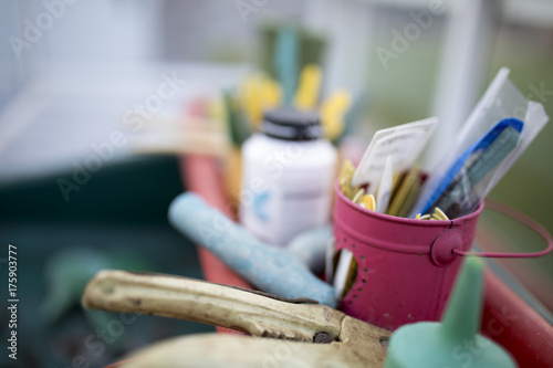 Close up of flower pot and tools in a green house or potting shed