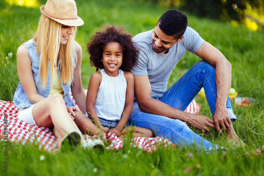 Picture of lovely couple with their daughter having picnic Picture of lovely couple with their daughter having picnic