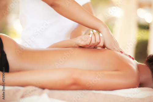 Spa massage. Relaxed smiling woman receiving a back massage