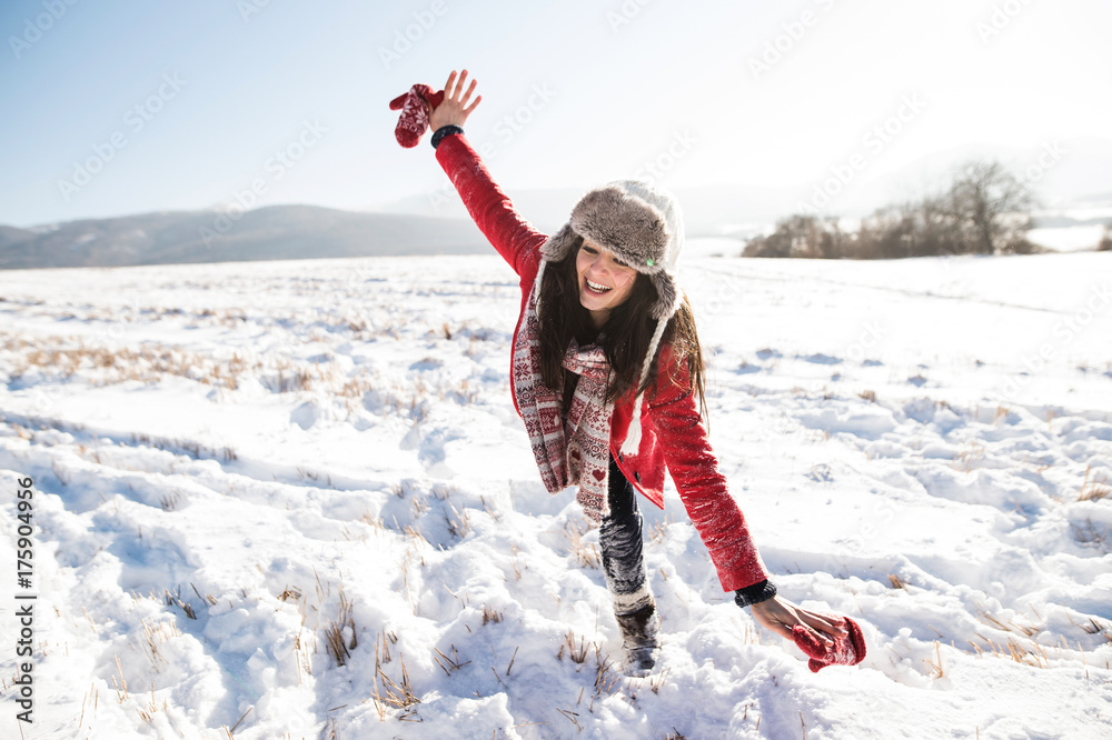Beautiful young woman with family, having fun in the snow.