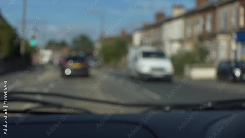 Car driver or front passenger point of view of English town or city street or road, blurry, blurred, handheld camera. Car driver or front passenger point of view of English town or city street or road, blurry, blurred, handheld camera.