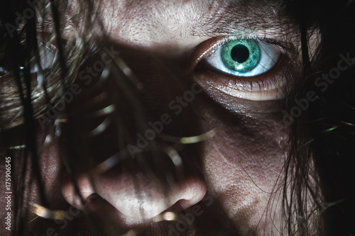 Portrait of a man with a green eye for horror or halloween. photo