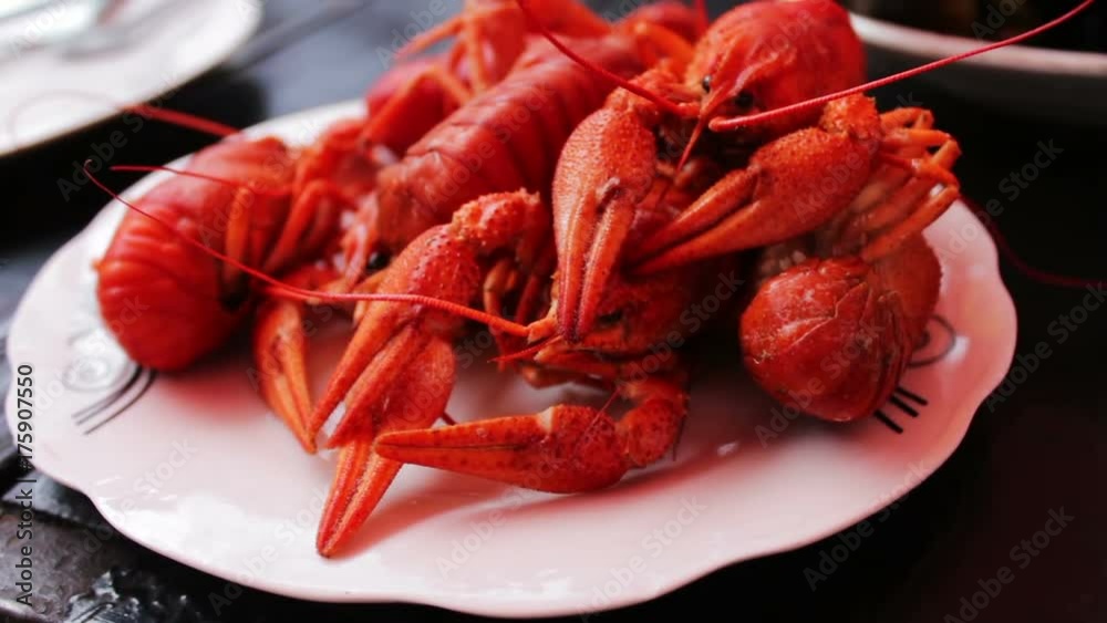 Freshly baked red crawfish on white plate on a table in a cafe Freshly baked red crawfish on white plate on a table in a cafe