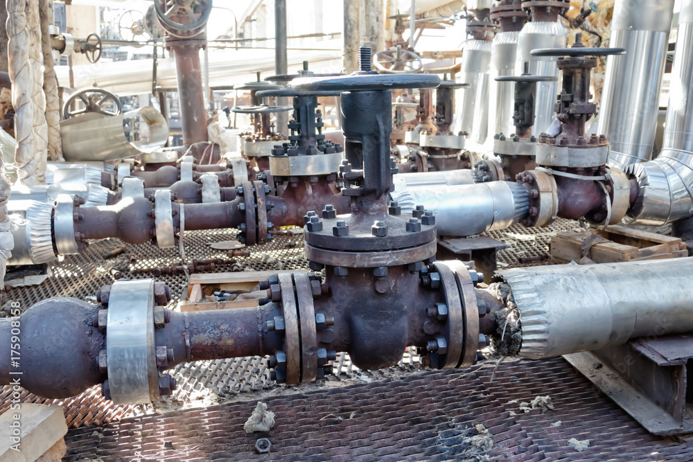 Old pipelines made of steel chromemolybdenum and valves on the service platform