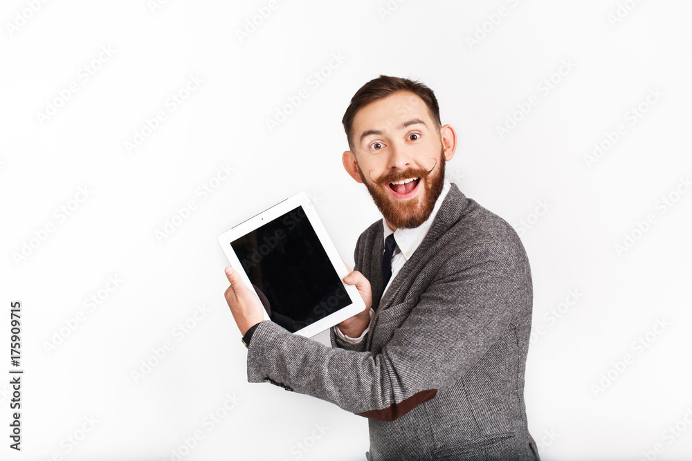 Surprised man with red beard works with tablet Surprised man with red beard works with tablet