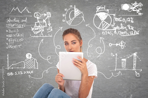 young woman working and planning on her tablet photo