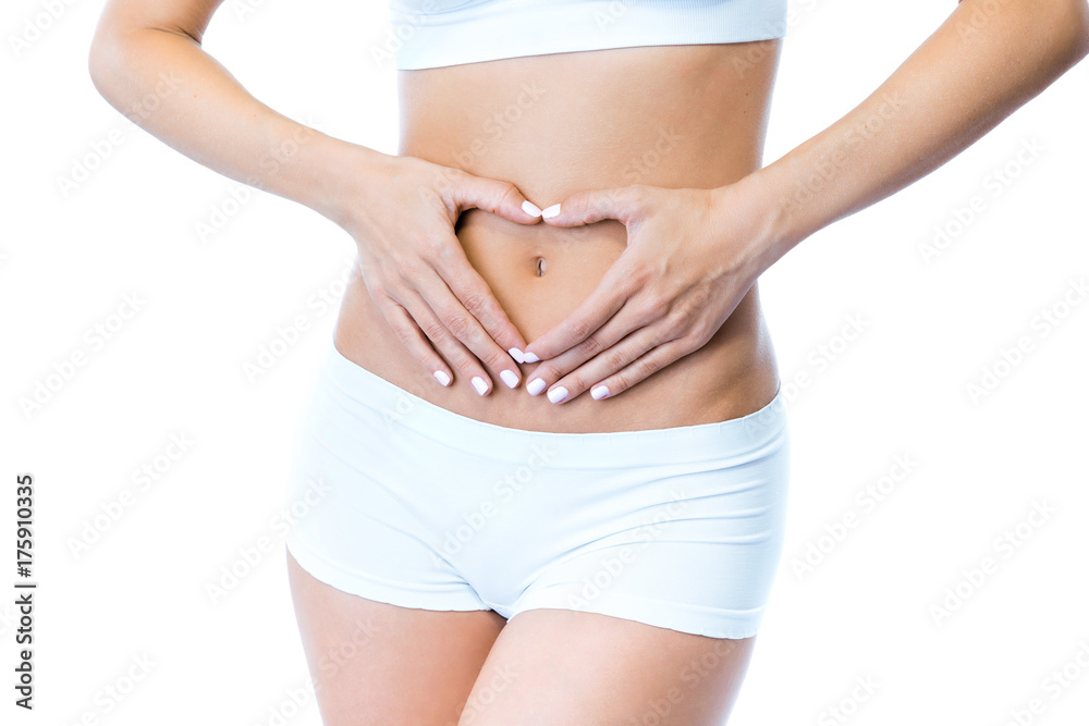 Beautiful young woman with hands on belly-stomach ache over white background.
