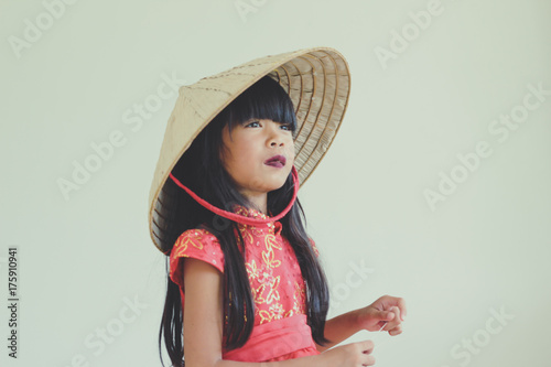 A cute asian kid girl wearing red Chinese dress for Chinese New year