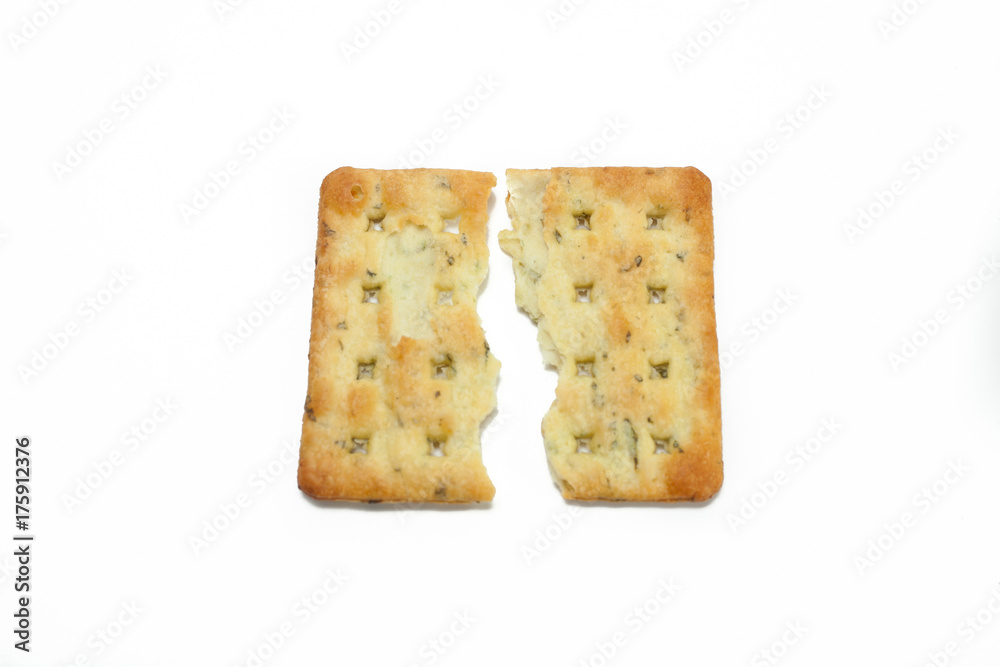 break into two vegetable cream cracker biscuits isolated white  background