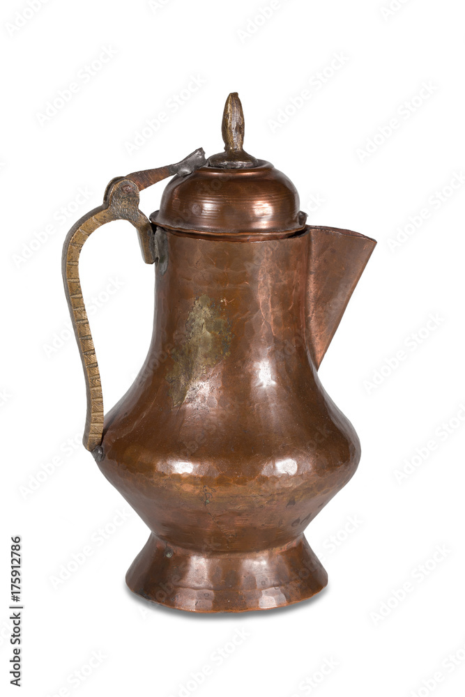 Old copper jug with a lid on a white background