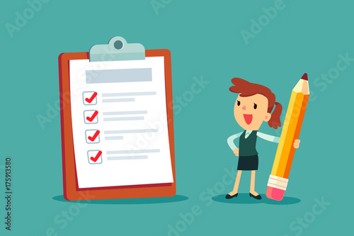 businesswoman holding a pencil looking at completed checklist on clipboard