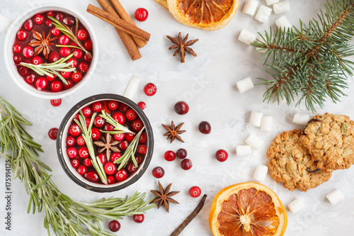 winter mulled wine with cranberries and spices on a light background