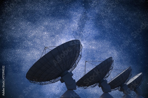 Array of satellite dishes or radio antennas against night sky. Space observatory. 3D rendered illustration.