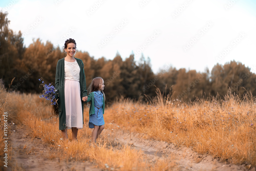 Mother with daughter walking on a road Mother with daughter walking on a road